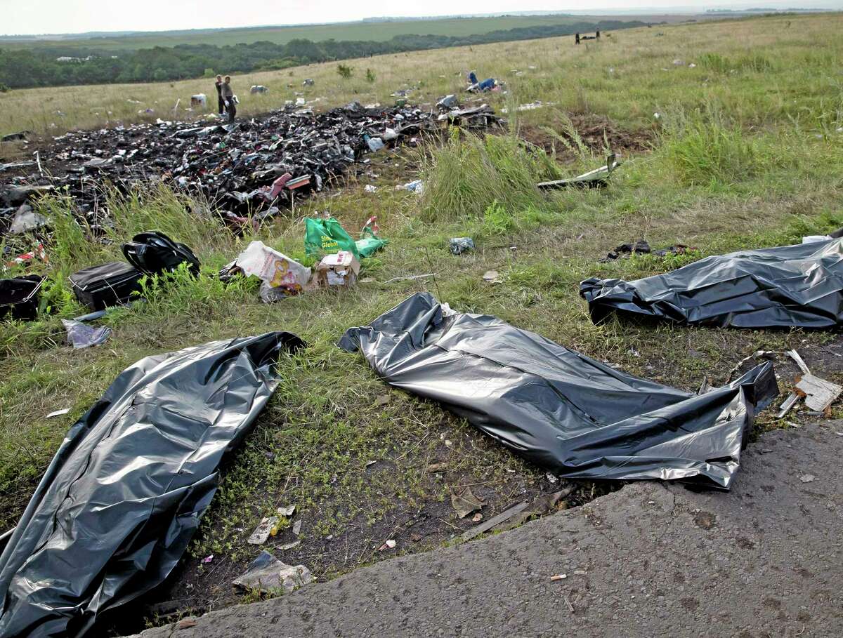 Bodies of victims are covered in plastic sacks at the crash site of Malaysia Airlines Flight 17 near the village of Hrabove, eastern Ukraine. World leaders demanded Friday that pro-Russia rebels who control the eastern Ukraine crash site of Malaysia Airlines Flight 17 give immediate, unfettered access to independent investigators to determine who shot down the plane.