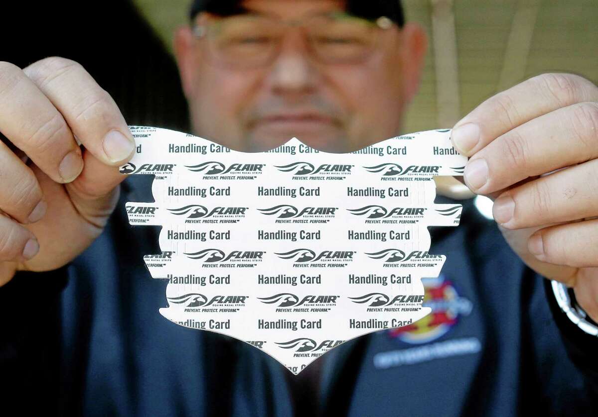 Alan Sherman, assistant trainer for Kentucky Derby and Preakness winner California Chrome, displays a nasal strip at Pimlico Race Course in Baltimore on Monday.