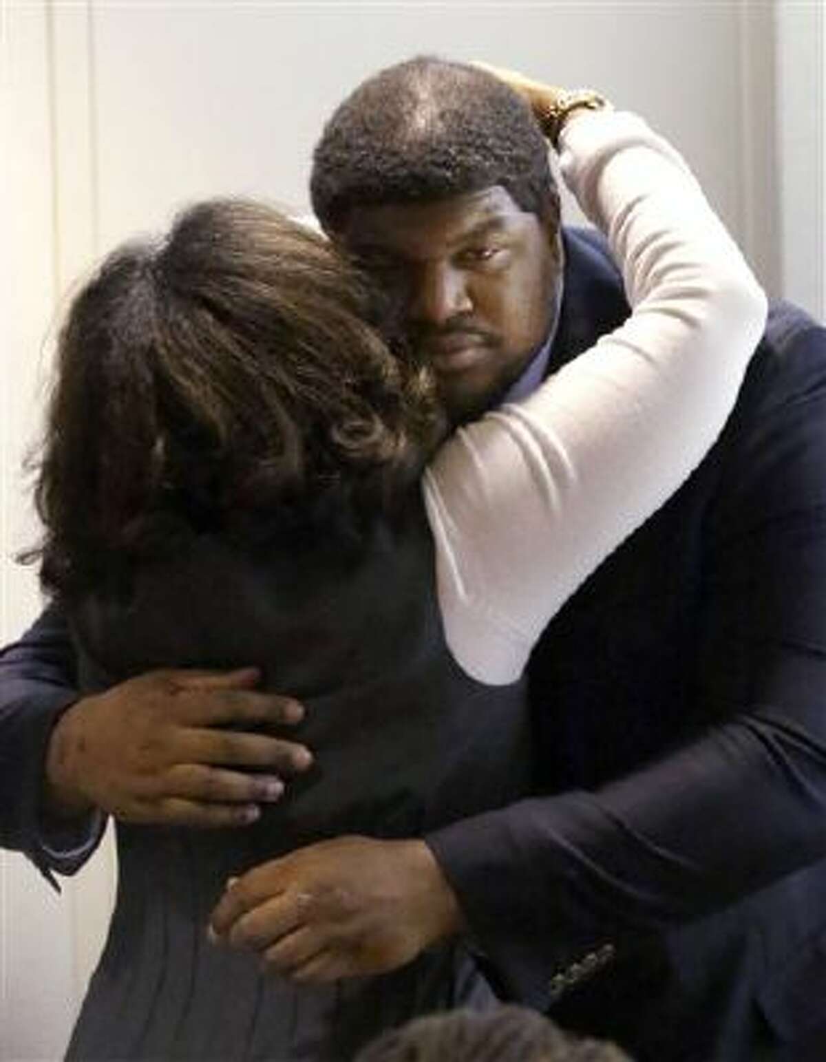 Former Dallas Cowboys NFL football player Josh Brent gets a hug from family after closing arguments in his intoxication manslaughter trial Tuesday, Jan. 21, 2014, in Dallas. The jury has begun deliberating in Brent's intoxication manslaughter trial after lawyers wrapped up their closing arguments Tuesday morning. Prosecutors accuse the former defensive tackle of drunkenly crashing his Mercedes near Dallas during a night out in December 2012, killing his good friend and teammate, Jerry Brown.
