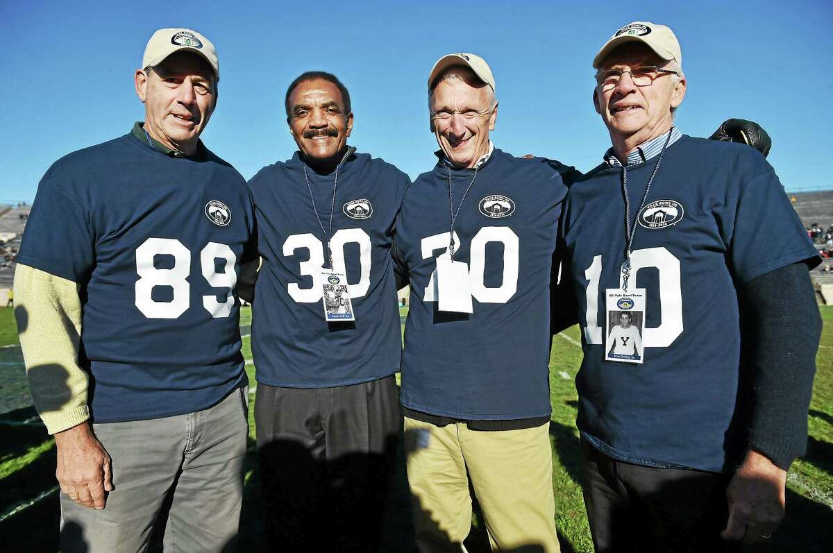 From left, tight end Bruce Weinstein, running back Calvin Hill, offensive tackle Kyle Gee and quarterback Brian Dowling were among 67 former Yale football players honored at halftime of the Bulldogs’ 44-30 win over Princeton on Saturday as part of the Yale Bowl’s centennial celebration.