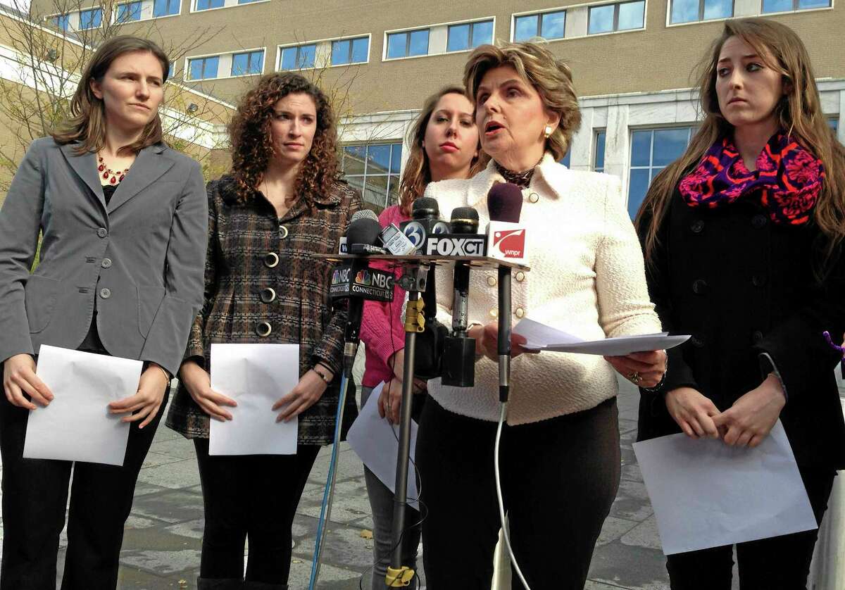 Attorney Gloria Allred, second from right, speaks to the media on Friday, Nov. 1, 2013 outside of U.S. District Court in Hartford, Conn. Allred filed a federal lawsuit on behalf of the four women with her, from left, Kylie Angell, Rosemary Richi, Erica Daniels and Carolyn Luby. UConn agreed to pay $1.3 million to settle the lawsuit in July 2014.