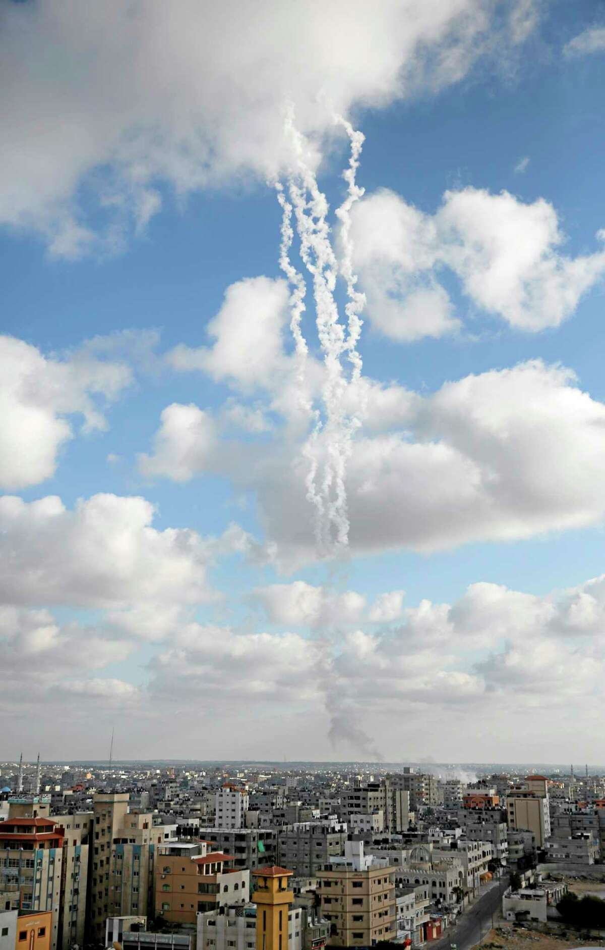 The smoke trail of multiple missiles fired by Palestinian militants from inside northern Gaza Strip, is seen as they make their way towards Israel, Friday, July 18, 2014. Israeli troops pushed deeper into Gaza on Friday to destroy rocket launching sites and tunnels, firing volleys of tank shells and clashing with Palestinian fighters in a high-stakes ground offensive meant to weaken the enclave's Hamas rulers.(AP Photo/Lefteris Pitarakis)