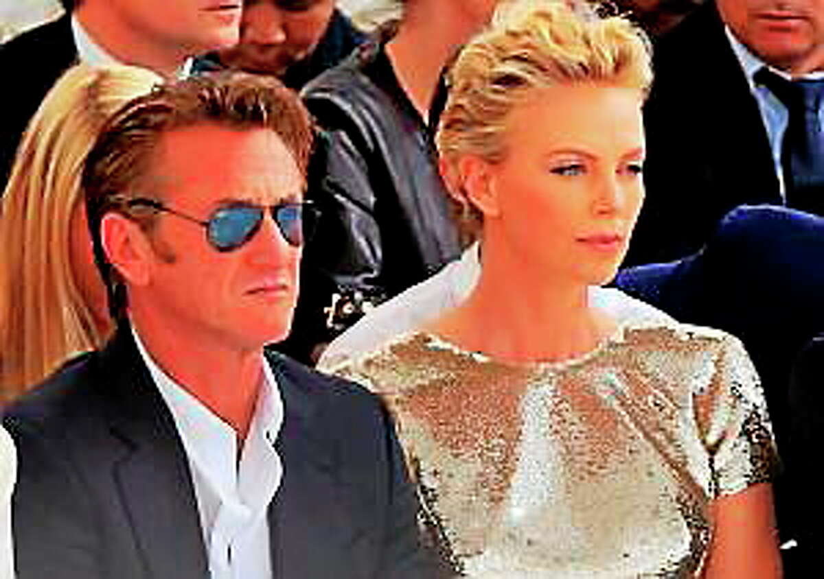 Actor Sean Penn and actress Charlize Theron attend Dior’s Fall-Winter 2014-2015 Haute Couture fashion collection, in Paris, France, Monday, July 7, 2014.