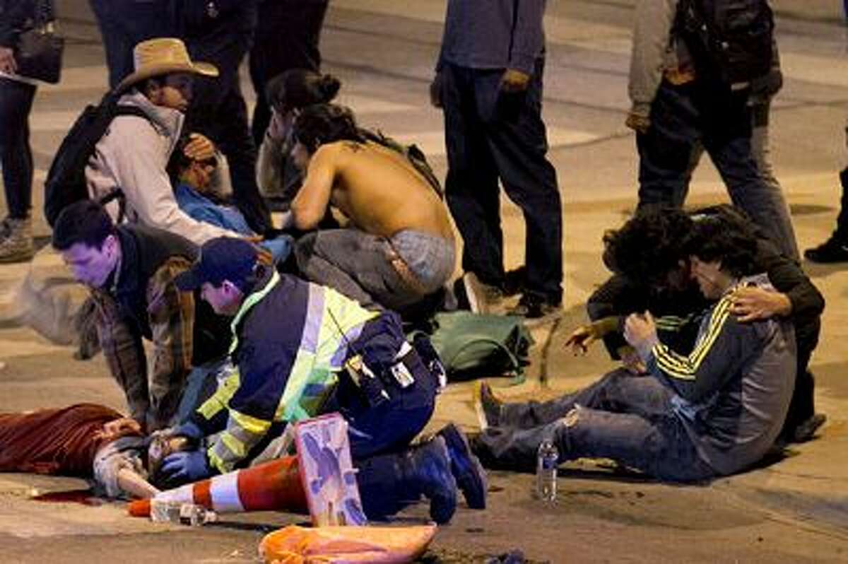 People are treated after being struck by a vehicle on Red River Street in downtown Austin, Texas, on Wednesday March 12, 2014. Police say two people were confirmed dead at the scene after a car drove through temporary barricades set up for the South By Southwest festival and struck a crowd of pedestrians. The condition of the victims shown is unknown. (AP Photo/Austin American-Statesman, Jay Janner) AUSTIN CHRONICLE OUT, COMMUNITY IMPACT OUT, MAGS OUT; NO SALES; INTERNET AND TV MUST CREDIT PHOTOGRAPHER AND STATESMAN.COM