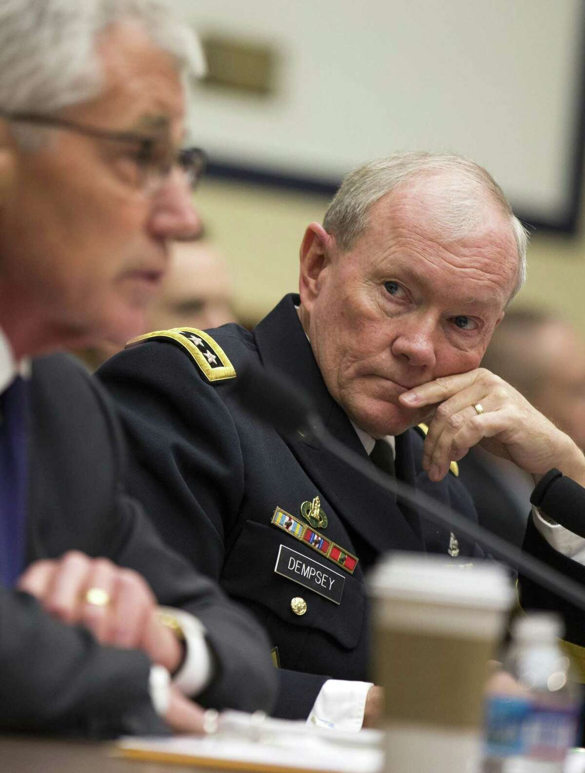 Joint Chiefs Chairman Gen. Martin Dempsey listens, at right, as Defense Secretary Chuck Hagel testifies on Capitol Hill in Washington, Thursday, Nov. 13, 2014, before the House Armed Services committee hearing on the Islamic State group. (AP Photo/Evan Vucci)