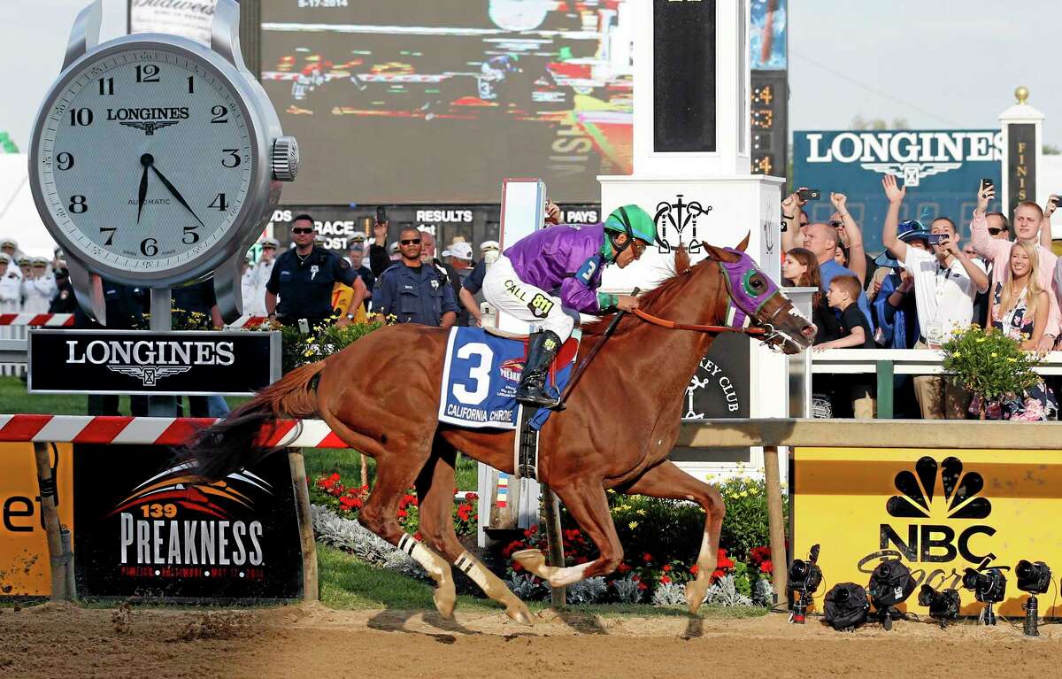 California Chrome, ridden by jockey Victor Espinoza, wins the 139th Preakness Stakes at Pimlico Race Course on Saturday in Baltimore.