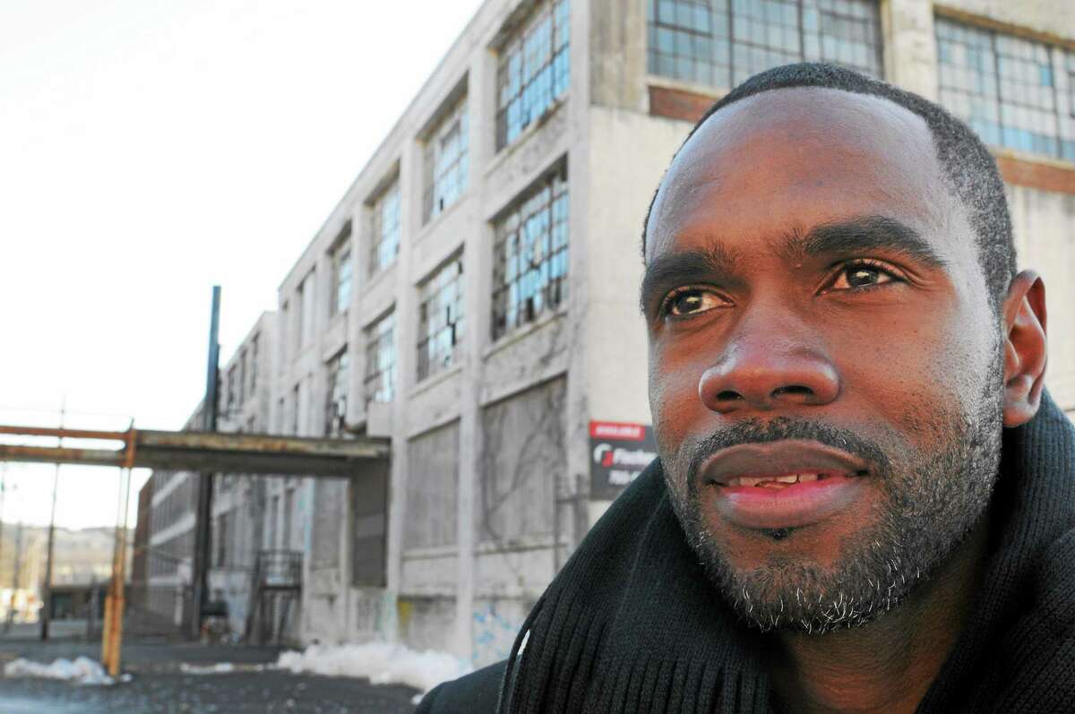 Developer Moustapha Diakhate stands next to a Farrel Corp. property on East Main Street in Ansonia in January 2013.