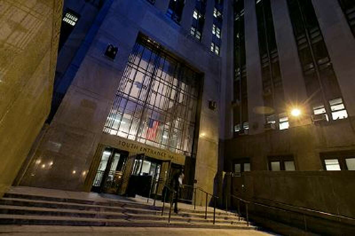A man leaves New York's Criminal Court Building, Tuesday evening March 11, 2014. Night Court is one of New Yorks more peculiar and paradoxical tourist traditions, a place visitors extol on travel websites while many residents hope never to wind up there. To travelers, its gritty entertainment, hard-knocks education or at least a chance to experience real-life law and order on a New York scale. (AP Photo/Richard Drew)