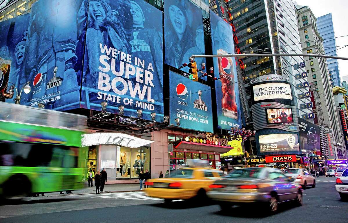 Large signs advertising the Super Bowl are seen on 42nd Street by Times Square on Monday in New York. Preparations for fan venues and activities for the upcoming Super Bowl are starting to appear along several blocks of Broadway, part of which has been dubbed “Super Bowl Boulevard.”