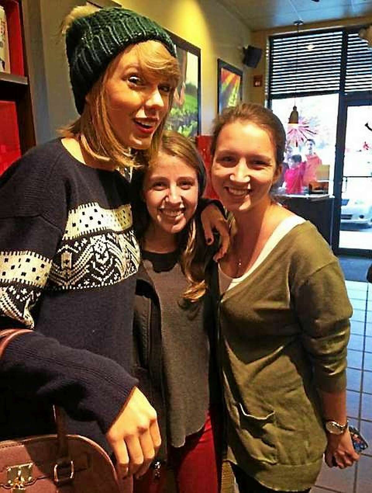 Quinnipiac University students Kathleen Barry, a junior physical therapy major, center, and Nicole Giuliani, a junior mathematics and masters of arts in education major, met Taylor Swift Thursday at the Starbucks in North Haven.