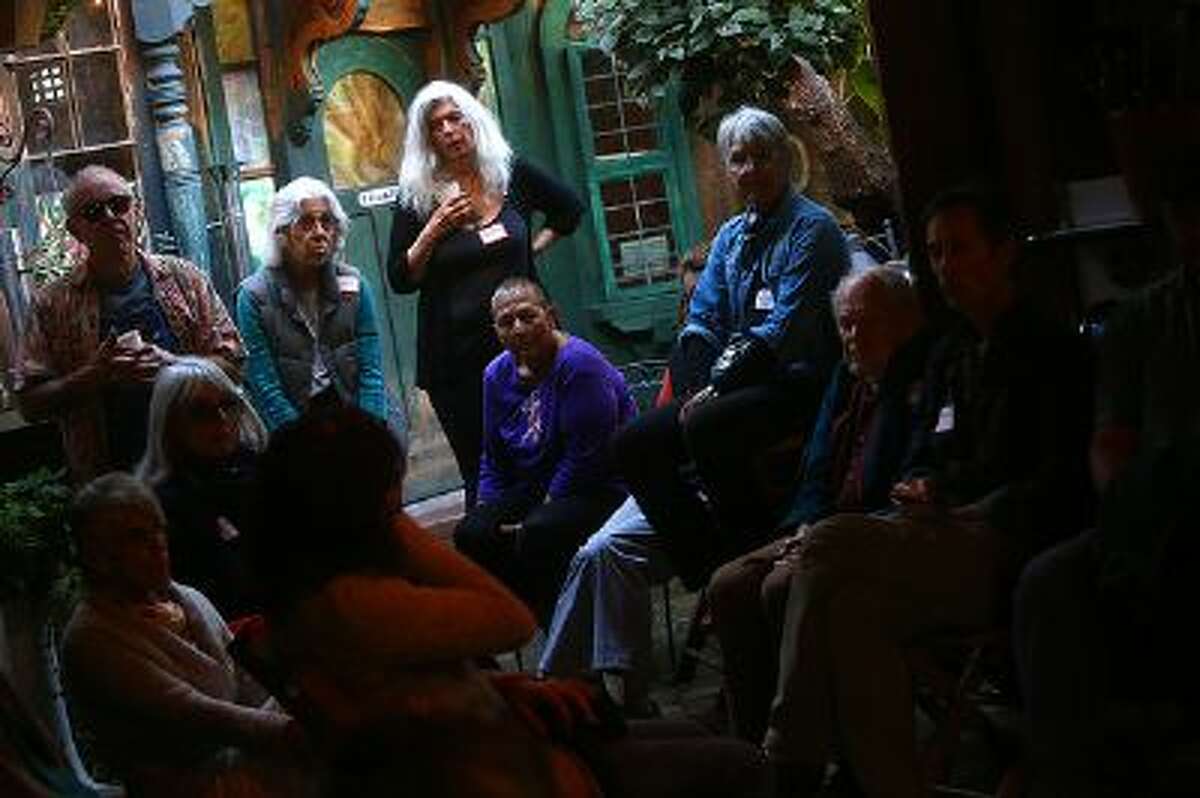 Christine Damen, center, co-hosts a Death Cafe event at 7 Squid Row in on Sunday, Nov. 10, 2013 in Santa Cruz, Calif. More than 20 participants took part in a conversation about death and grief at the event.