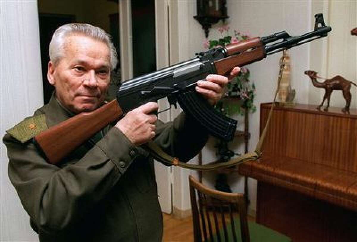 Mikhail Kalashnikov shows a model of his world-famous AK-47 assault rifle at home in the Ural Mountain city of Izhevsk, 1000 km (625 miles) east of Moscow in this 1997 file photo.