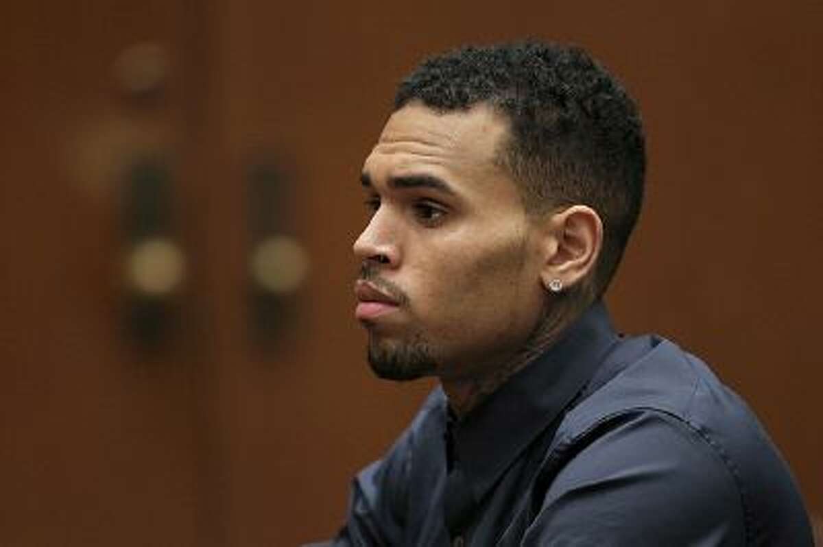 LOS ANGELES, CA - FEBRUARY 03: R&B singer Chris Brown appears in court for a probation progress hearing on February 3, 2014 in Los Angeles, California. Brown has been on probation since pleading guilty to assaulting his then girlfriend, singer Rihanna, after a pre-Grammy Awards party in 2009. He has been in anger management treatment program and performing community service requirements but failure to meet probation requirements could be even further complicated by assault charges he and bodyguard Christopher Hollosy face stemming from an incident outside the W hotel in Washington D.C. last October. (Photo by David McNew/Getty Images)
