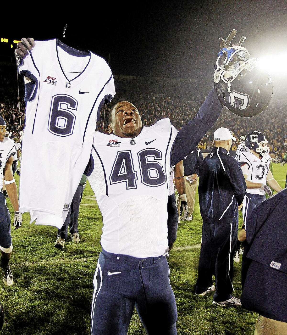 UConn linebacker Sio Moore carries the jersey of Jasper Howard after the Huskies defeated Notre Dame 33-30 in double overtime on Nov. 21, 2009, in South Bend, Ind.