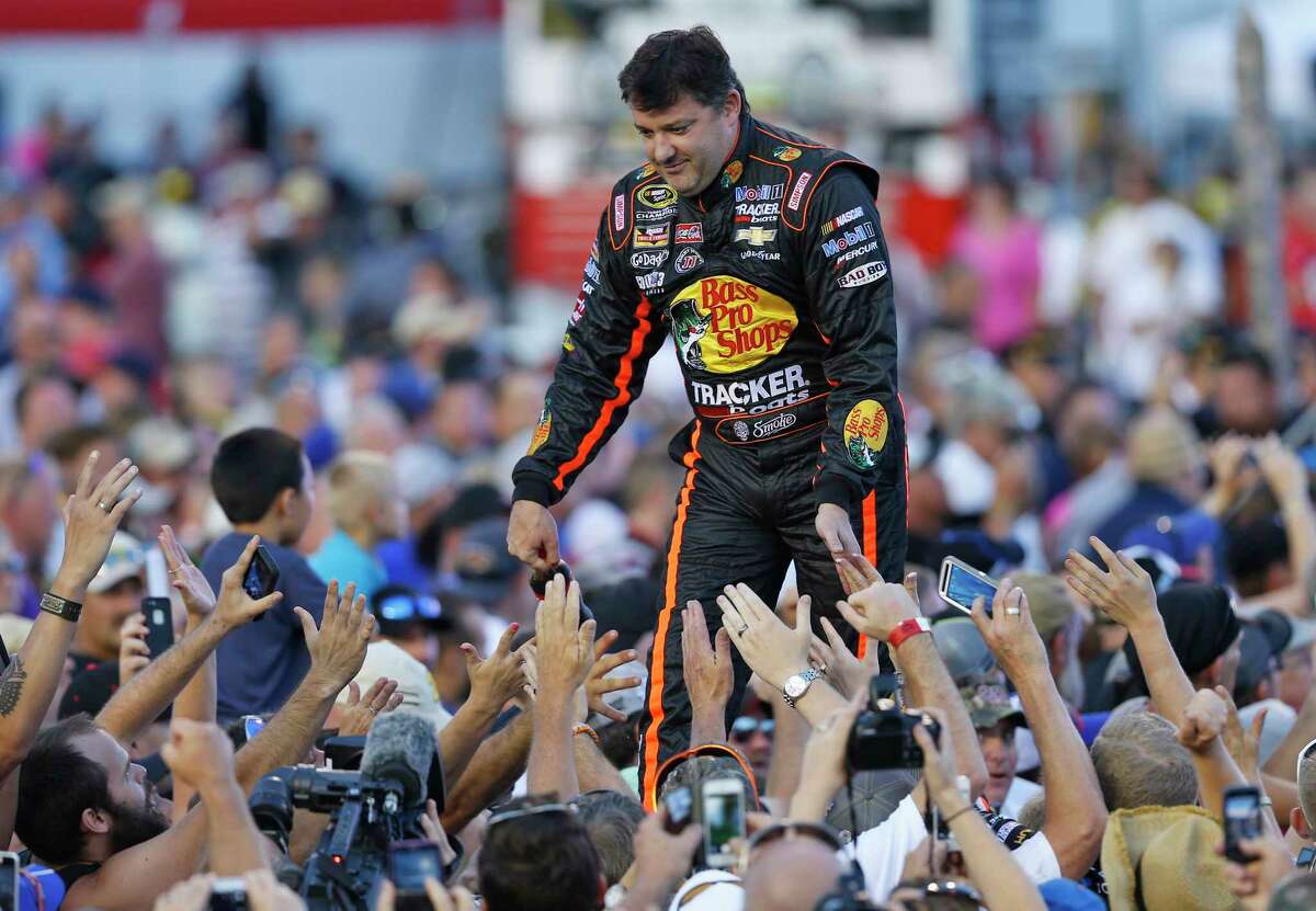 Tony Stewart greets fans during driver introductions prior to the start of the NASCAR Sprint Cup race at Richmond International Raceway on Saturday in Richmond, Va.