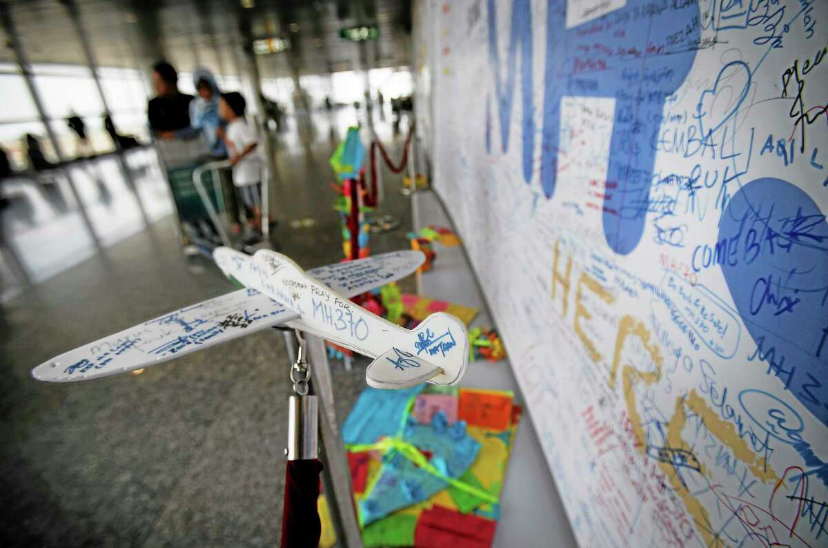 A foam plane with messages and cards with personalized messages dedicated to people involved with the missing Malaysia Airlines jetliner MH370, are placed in the viewing gallery at Kuala Lumpur International Airport, Saturday, March 15, 2014 in Sepang, Malaysia. A Malaysian passenger jet missing for more than a week had its communications deliberately disabled and its last signal came about seven and a half hours after takeoff, meaning it could have ended up as far as Kazakhstan or deep in the southern Indian Ocean, Malaysia's Prime Minister Najib Razak said Saturday.(AP Photo/Wong Maye-E)