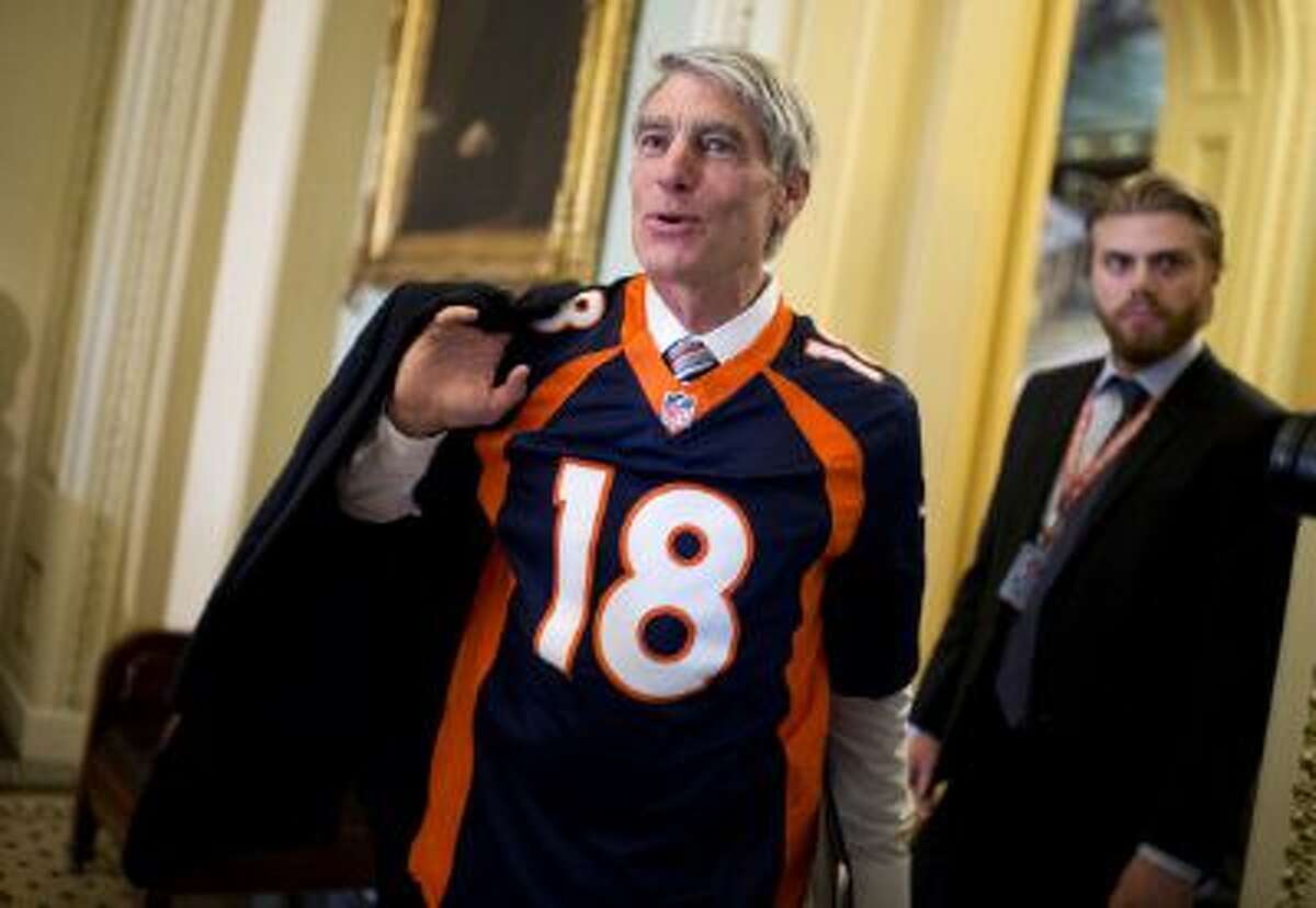 Sen. Mark Udall, D-Colo., sports a Denver Broncos jersey on Capitol Hill ahead of the Super Bowl.