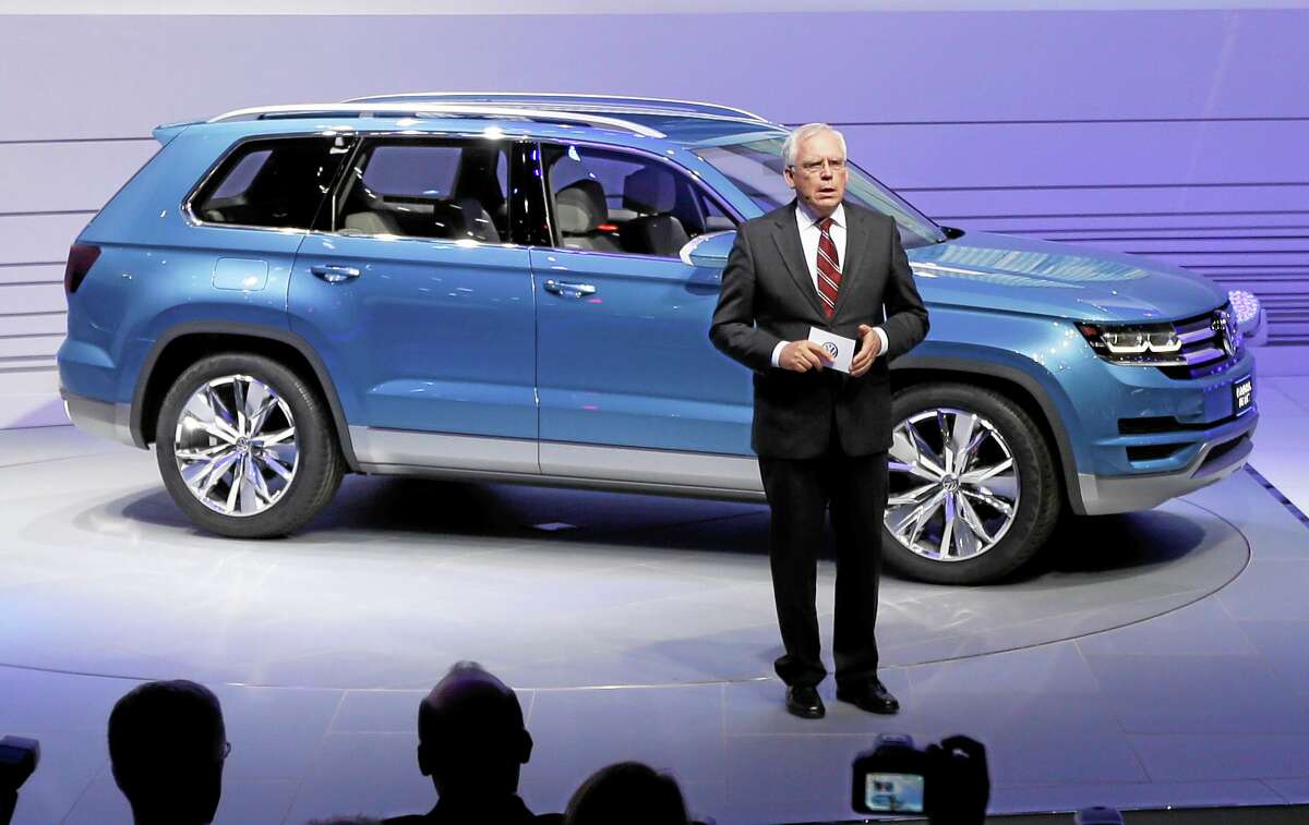 In this Jan. 14, 2013, photo, Ulrich Hackenberg, Volkswagen director of produce development for power trains, stands next to the Volkswagen CrossBlue SUV concept vehicle during the North American International Auto Show in Detroit.
