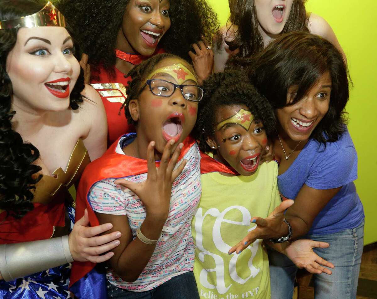 Joy Sewing, Houston Chronicle Fashion and Beauty Editor, right, poses with girls and characters during a Wonder Woman Bowling Party for 30 area girls ages 7 to 12 held at Bowlmor, 925 Bunker Hill Road, as part of her #YearOfJoy project Monday, July 24, 2017, in Houston.