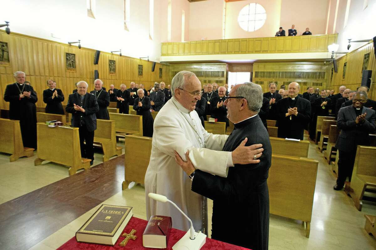 In this picture made available by the Vatican newspaper L'Osservatore Romano, Pope Francis, greets Monsignor Angelo De Donatis at the end of his retreat for spiritual exercises, in Ariccia, Italy, Friday, March 14, 2014. Francis and the heads of Vatican offices traveled to Ariccia, in the hills south of Rome, where the Society of St. Paul offered up a retreat house for spiritual exercises through Friday. Jesuits typically do such Lenten retreats away from home, and Francis is breaking with recent papal tradition of prayers and meditation at the Vatican during the 40-day Lenten period preceding Easter. (AP Photo/L'Osservatore Romano)