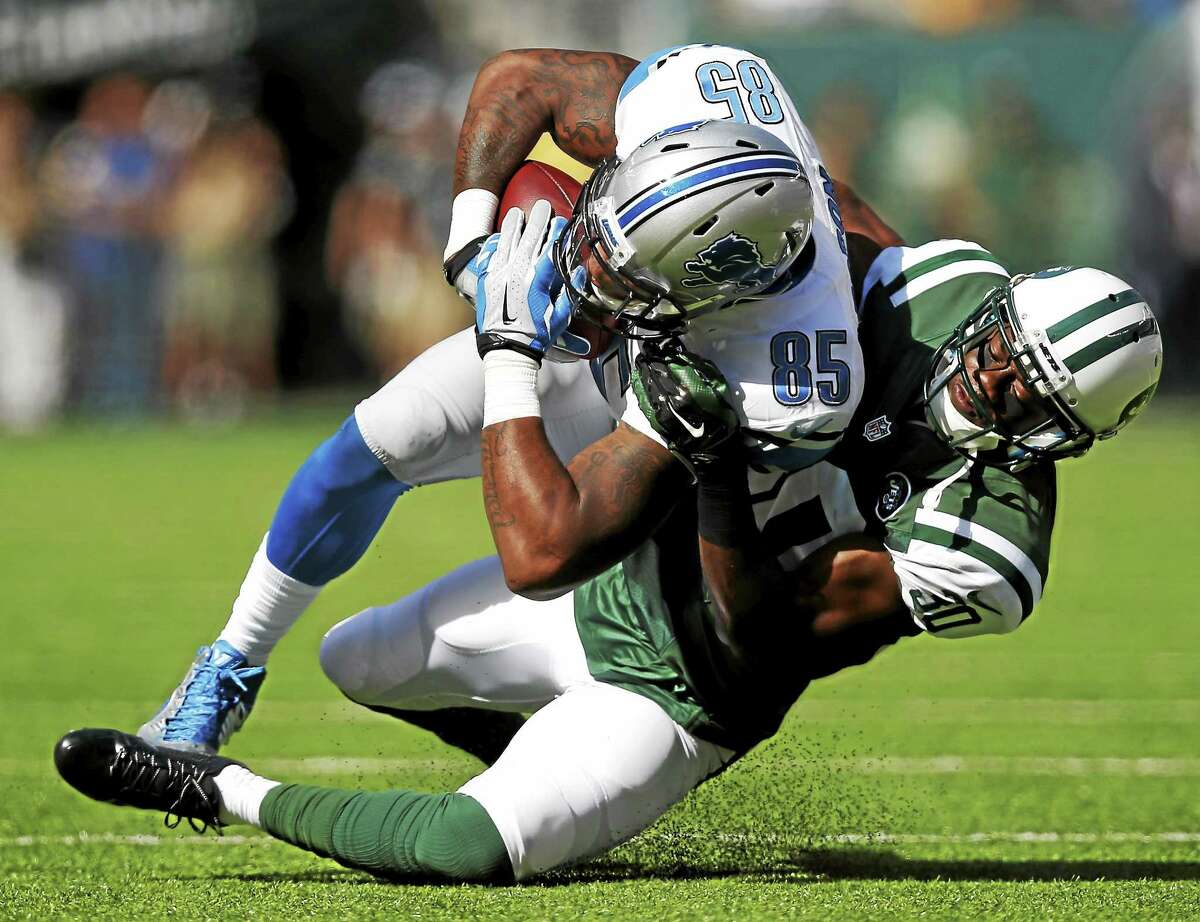Detroit Lions tight end Eric Ebron is tackled by New York Jets cornerback Darrin Walls during a Sept. 28 game in East Rutherford, N.J.