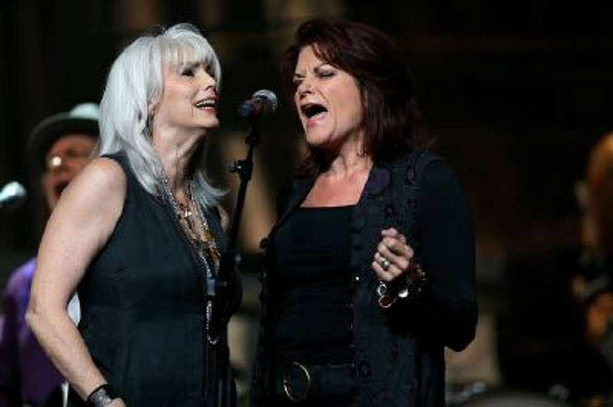 Emmylou Harris, left, and Rosanne Cash perform during the Americana Music Honors and Awards Show on Wednesday, Sept. 18, 2013, in Nashville, Tenn.