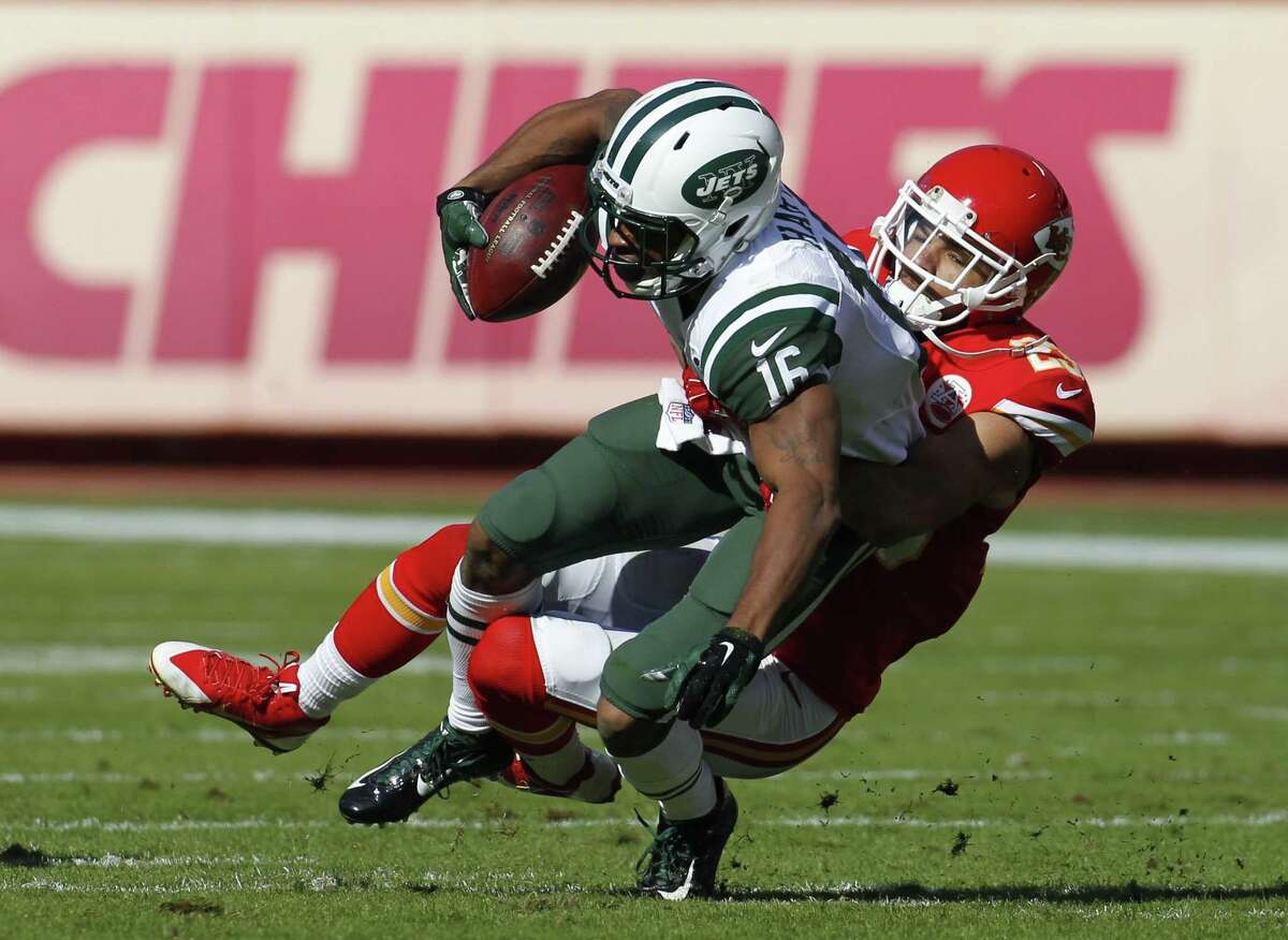 New York Jets receiver Percy Harvin is dragged down by Chiefs cornerback Phillip Gaines during Sunday’s game in Kansas City, Mo.