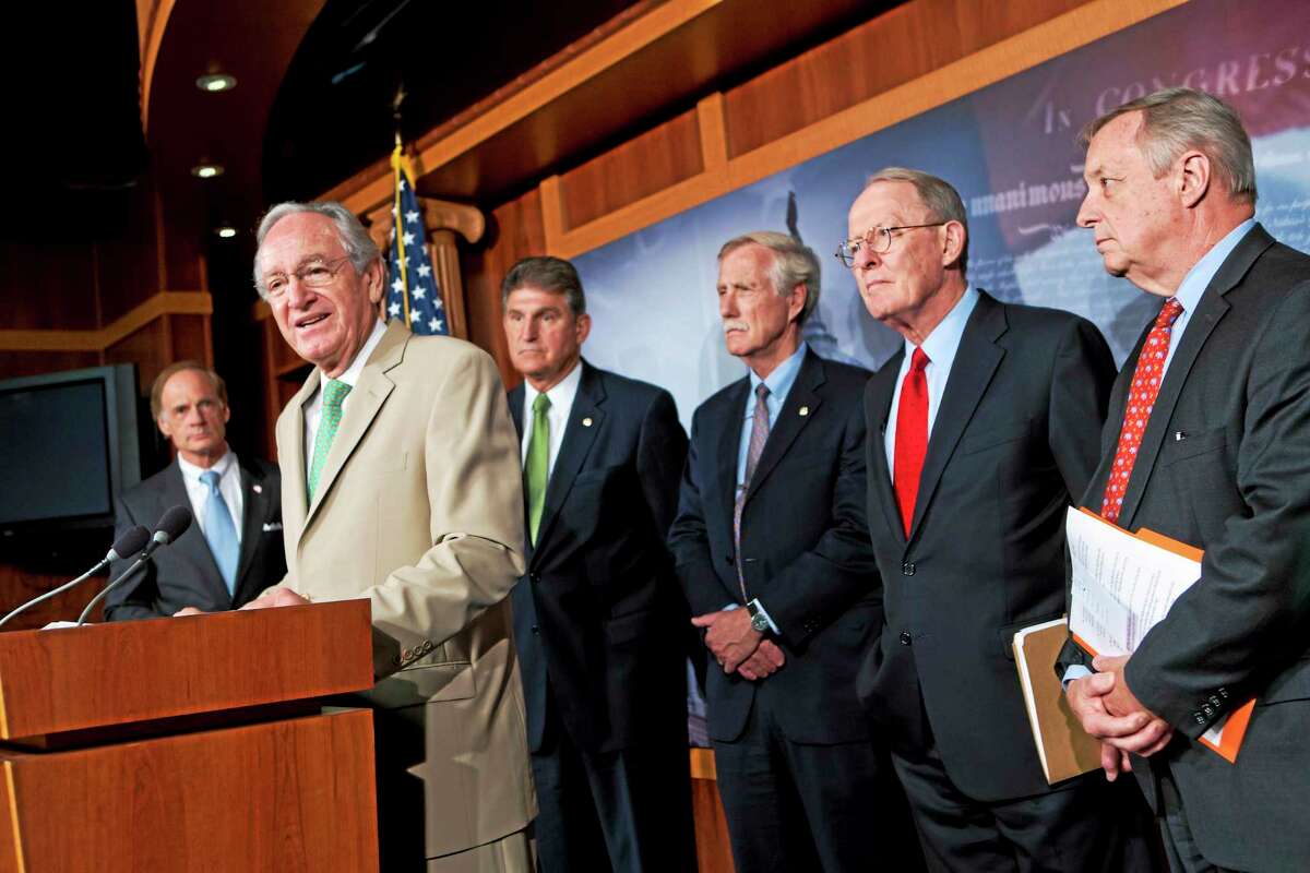 In this July 18, 2013, photo, U.S. Sen. Tom Harkin, D-Iowa, chairman of the Senate Education Committee, announces to reporters that a bipartisan agreement was reached on rates for government student loans in Washington. From left are Sen. Tom Carper, D-Del., Harkin, Sen. Joe Manchin, D-W.V., Sen. Angus King, I-Maine, Sen. Lamar Alexander, R-Tenn., and Sen. Dick Durbin, D-Ill.