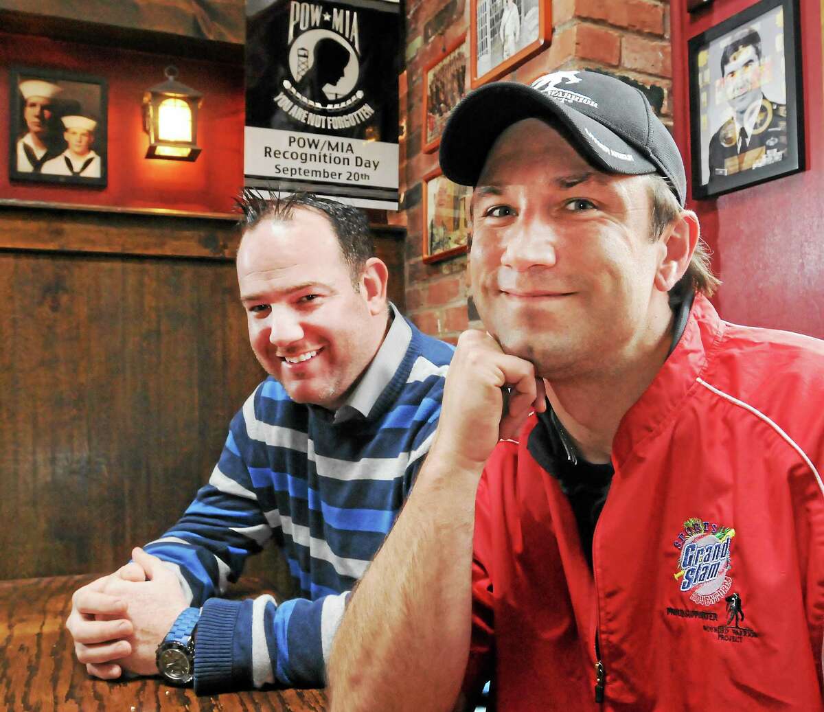 Damian Cashman, co-owner of O’Toole’s Irish Pub in New Haven, left, and New Haven Firefighter Douglas McBrierty, an Army veteran of Iraq, at the pub.