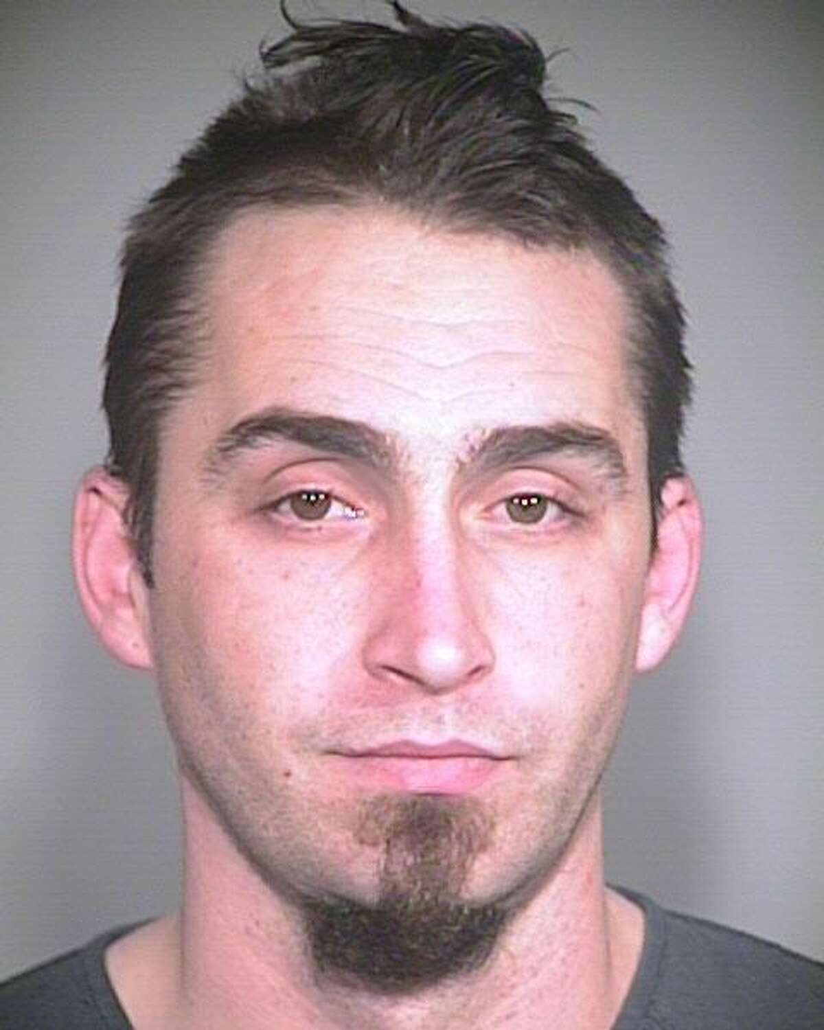 This image released by the Portland, Ore., Police Bureau, shows David Kalac, 33, who police say is a suspect in the killing of a woman in Port Orchard, Wash., where graphic photos of the victim's body were posted online hours before before police found the body. ( AP Photo/Portland Police Bureau)