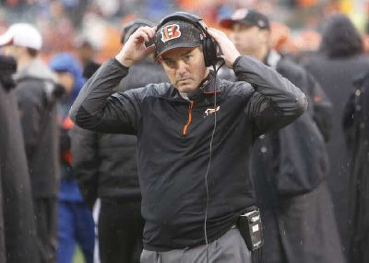 Cincinnati Bengals defensive coordinator Mike Zimmer adjusts his head set in the second half of an NFL wild-card playoff football game against the San Diego Chargers Sunday, Jan. 5, 2014.