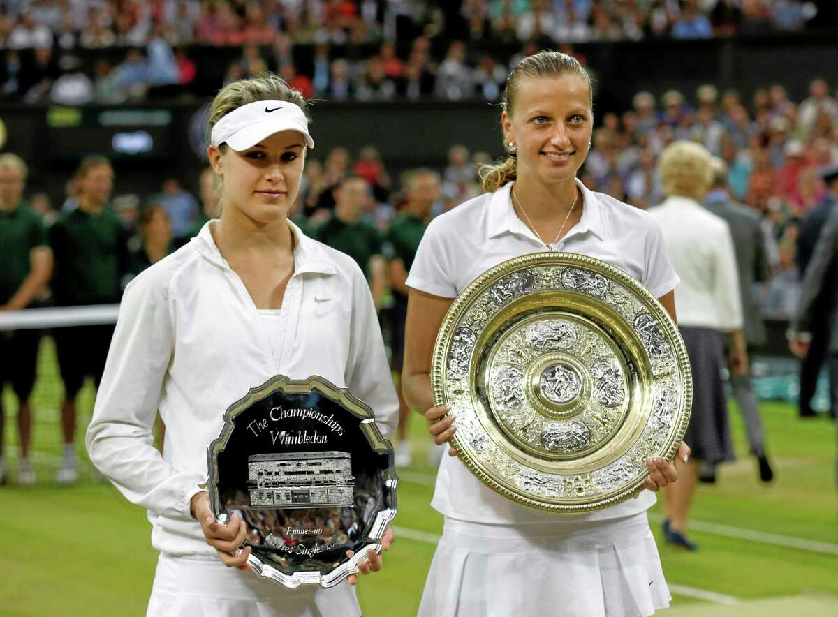 Petra Kvitova, right, holds the trophy after winning the women’s final against Eugenie Bouchard, left, on Saturday at the All England Lawn Tennis Championships in Wimbledon, London. Both players will be in the field for next month’s Connecticut Open at the Connecticut Tennis Center at Yale.