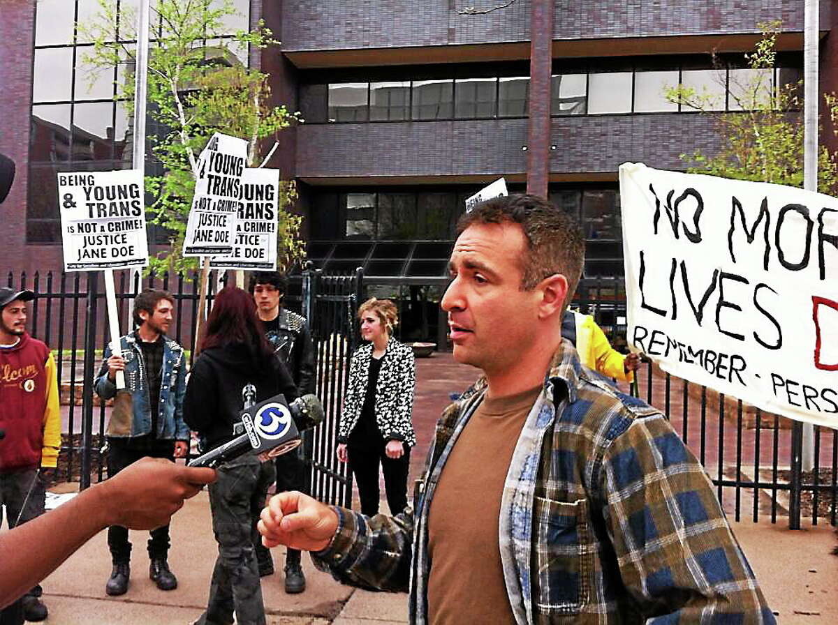 Jane Doe’s attorney, Aaron Romano, speaks to a reporter at a protest against his teen client’s incarceration in an adult prison in Connecticut.