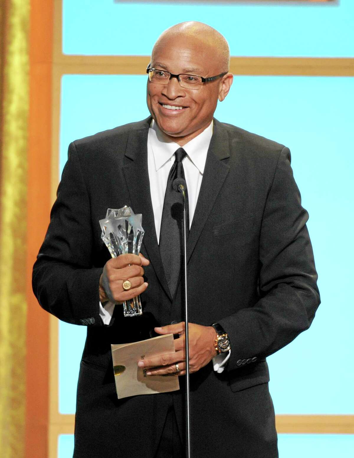 In this Monday, June 10, 2013, photo, Larry Wilmore accepts the best talk show award for “The Daily Show with Jon Stewart” at the Critics’ Choice Television Awards in the Beverly Hilton Hotel in Beverly Hills, Calif. Writer-comic Larry Wilmore of “The Daily Show” has earned Stephen Colbert’s coveted Comedy Central timeslot following Jon Stewart each night.