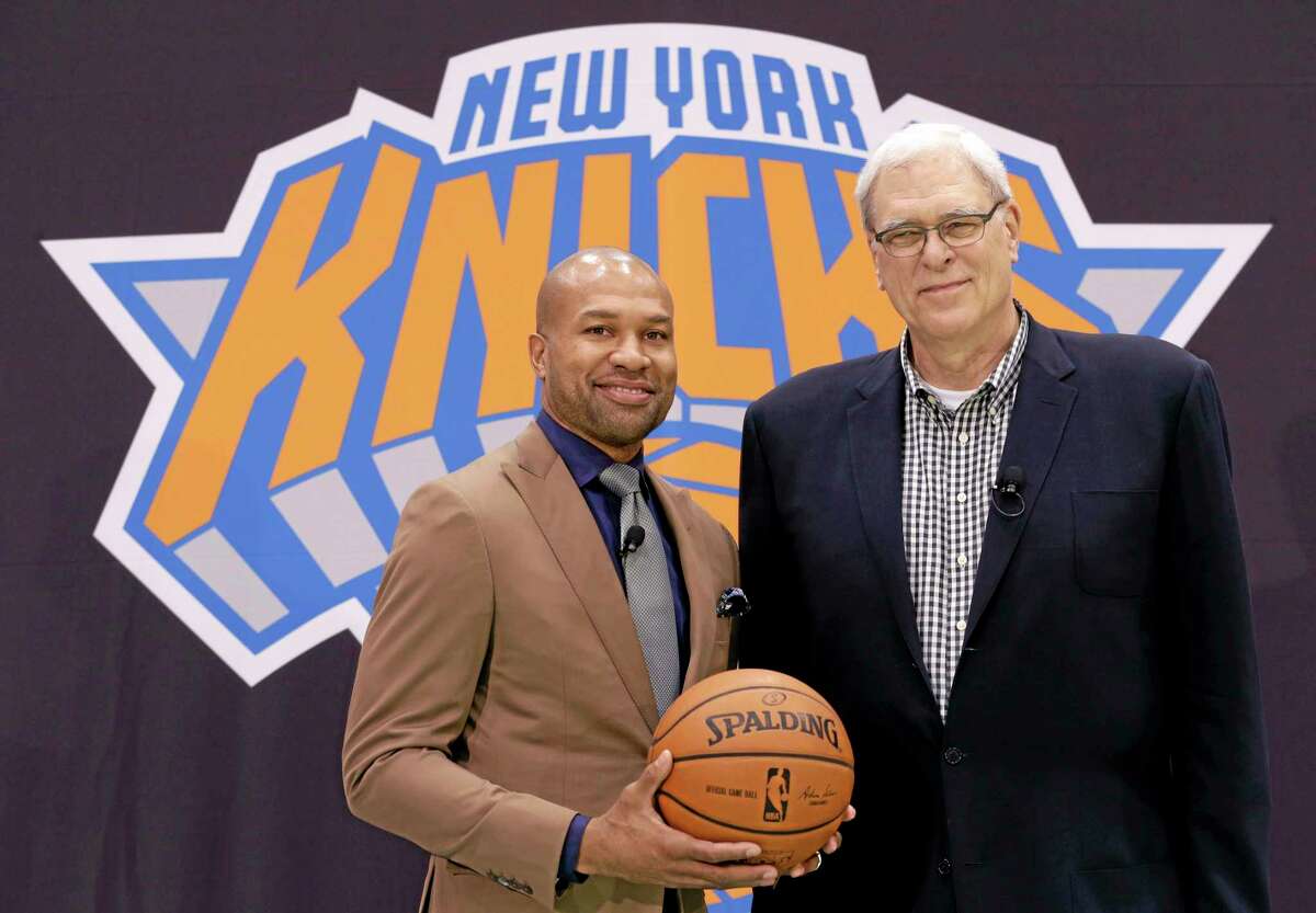 New York Knicks president Phil Jackson, right, poses with Derek Fisher during a news conference on June 10 in Tarrytown, N.Y.