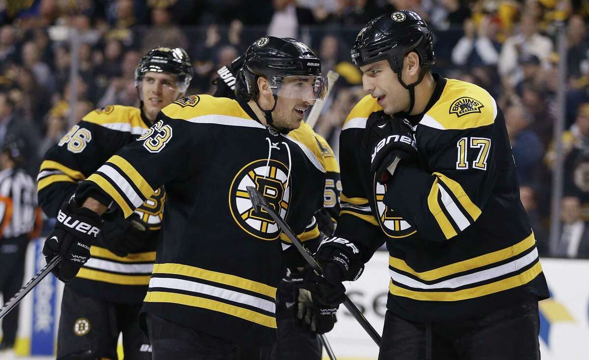 The Bruins’ Milan Lucic (17) celebrates a goal with teammate Brad Marchand during a recent game.