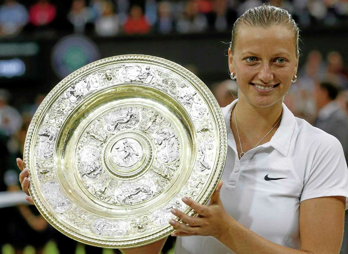 Petra Kvitova holds the trophy after winning the women’s final against Eugenie Bouchard Saturday at the All England Lawn Tennis Championships in Wimbledon, London.