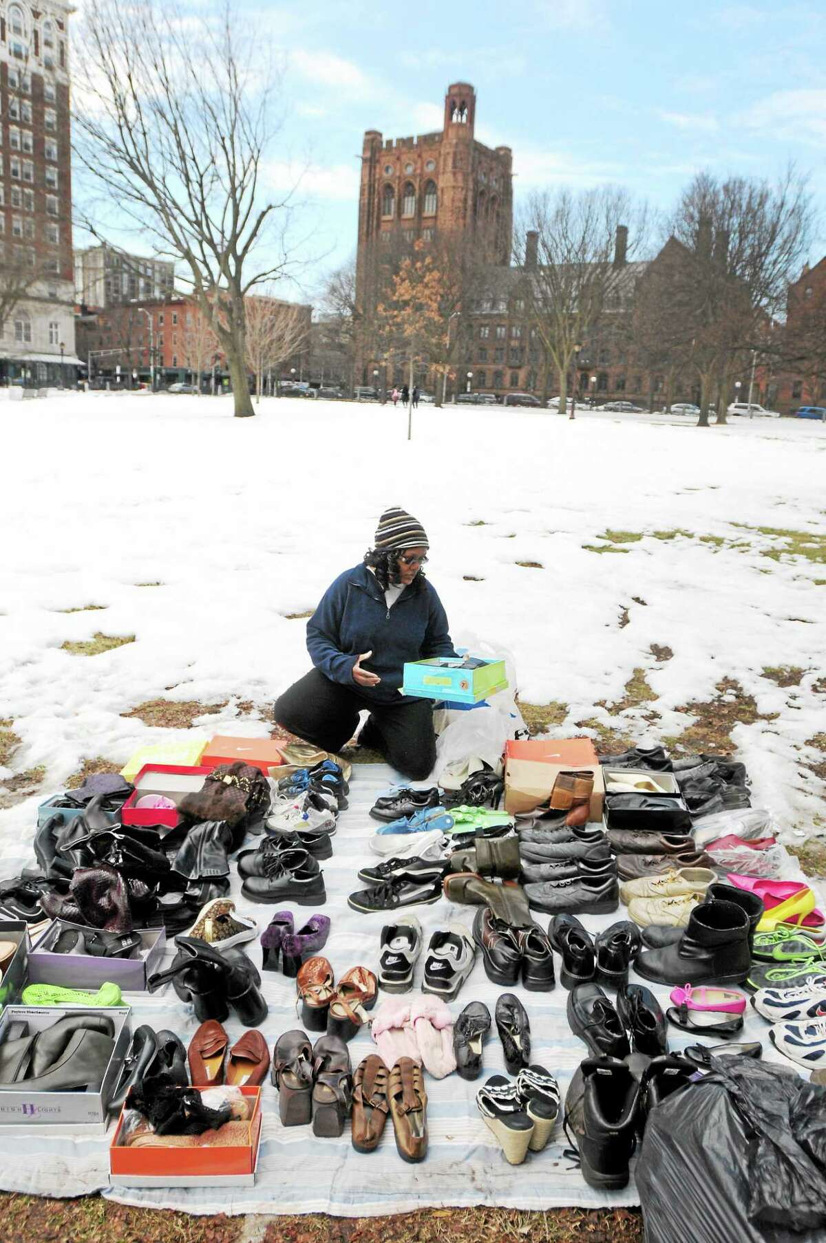 (Photo by Peter Hvizdak-New Haven Register) Lisa Hargreaves of Hamden, a worker for JHOP, Jesse's Homeless Outreach Project, lines up shoes for the homeless and needy on the upper green in New Haven before JHOP workers handed them out along with free food, clothes, toiletries and other items Saturday afternoon March 8, 2014 in New Haven.