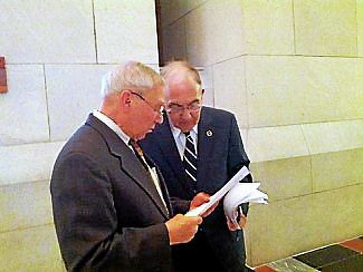 Retired Supreme Court Justice David Borden talks to Majority Leader Martin Looney.