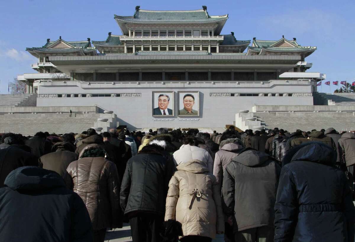 FILE - In this Dec. 17, 2014, file photo, North Koreans gather at Kim Il Sung Square in Pyongyang, most bowing toward portraits of their late leaders as an act of respect, to mark the third anniversary of the death of Kim Jong Il.