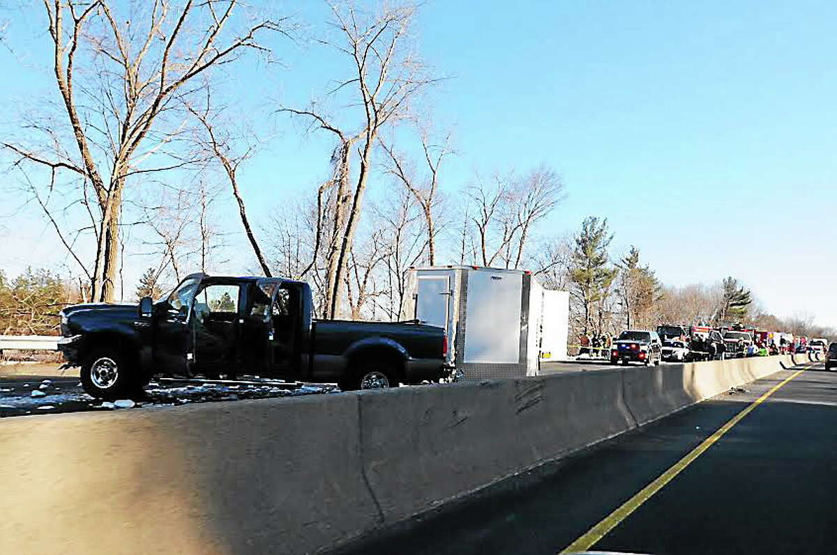 A pickup truck towing a trailer full of barrels of chemicals jackknifed on northbound Route 8 Thursday.