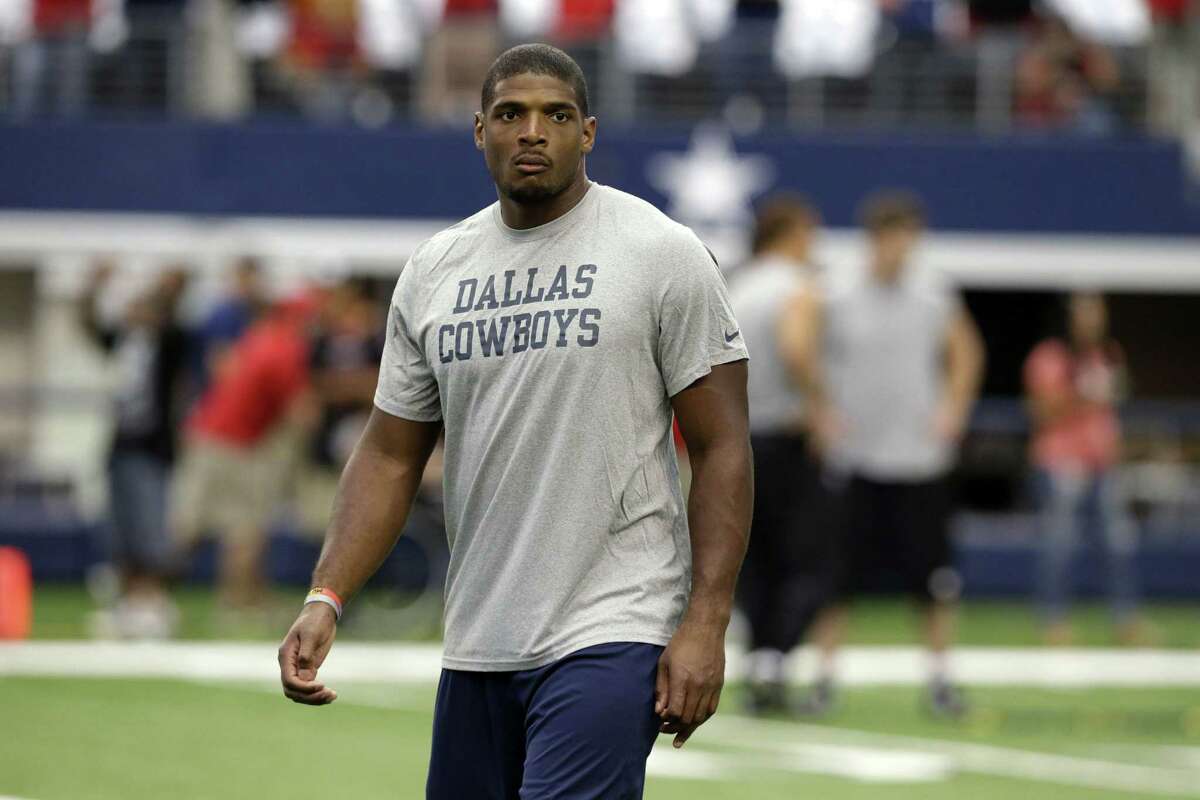 This photo taken Sept. 7, 2014 shows former Dallas Cowboys Michael Sam walking on the field before the first half of an NFL football game in Arlington, Texas.
