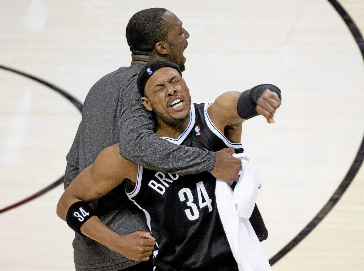Brooklyn Nets forward Paul Pierce reacts with teammate Andray Blatche, right, after defeating the Toronto Raptors in Game 7 in Toronto on Sunday.