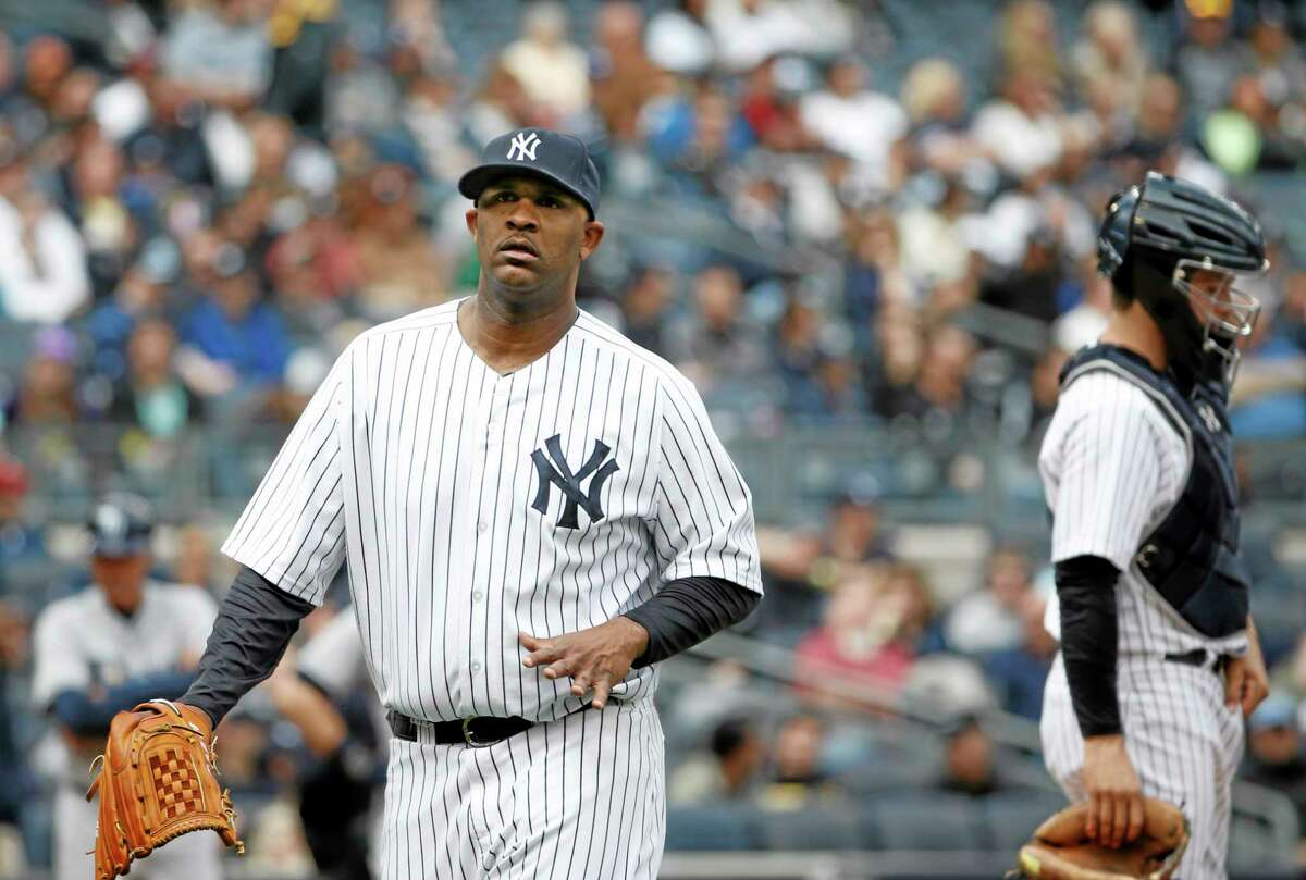Yankees starting pitcher CC Sabathia flexes his pitching hand while leaving Sunday’s game after giving up a fourth-inning double to Wil Myers on Sunday.