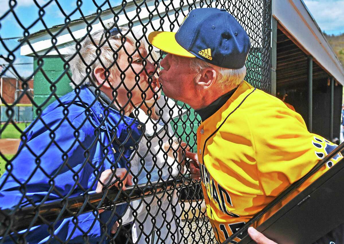 Long-time Quinnipiac baseball coach Dan Gooley gives his wife Susan a kiss after being honored by the university for his 33-year career with the school. Gooley is retiring after this season, and Sunday’s game was possibly his last home game.