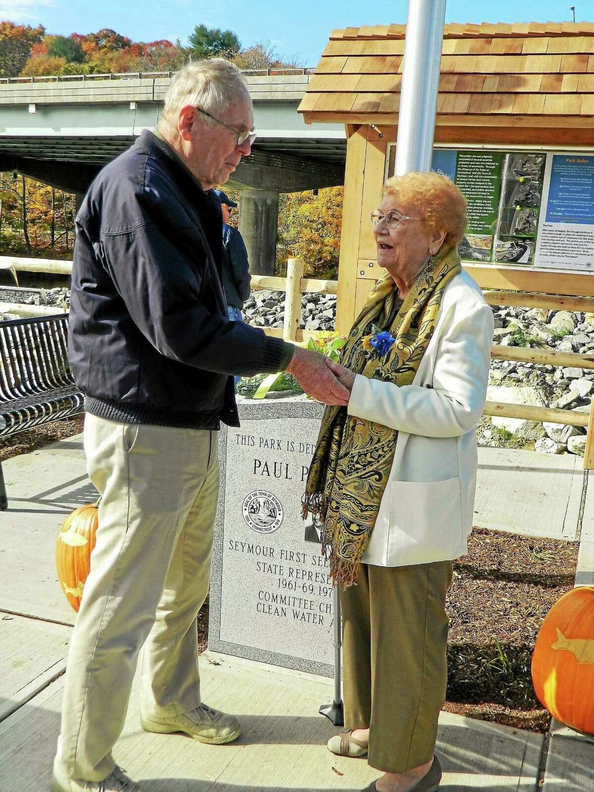 Mildred Pawlak, wife of late Paul Pawlak Sr., is congratulated by an unidentified person during the opening of the bypass Thursday.