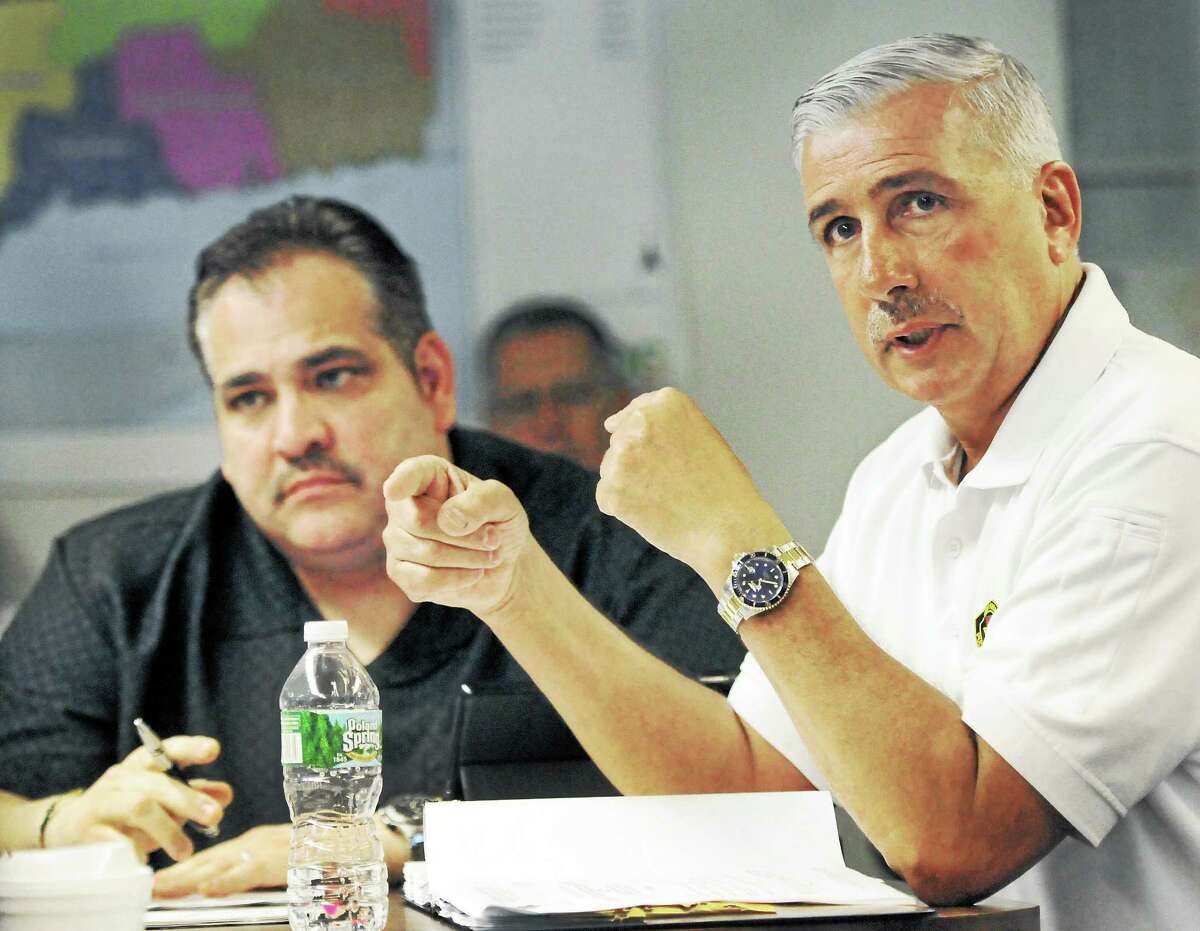 Abe Colon, West Haven’s 911 emergency reporting system director, left, and Rick Fontana, New Haven’s deputy director of emergency operations, attend a CMED Board of Directors meeting May 5 at the South Central Regional Council of Governments offices in North Haven.