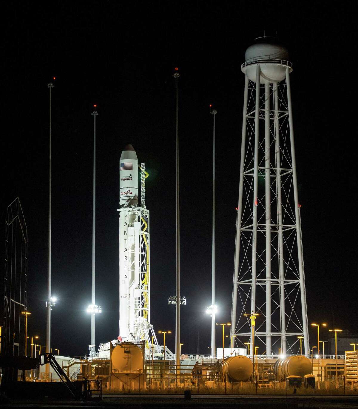 The Orbital Sciences Corporation Antares rocket, with the Cygnus spacecraft onboard, is seen after being raised into vertical position on launch Pad-0A, Oct. 25, 2014, at NASA’s Wallops Flight Facility in Virginia.