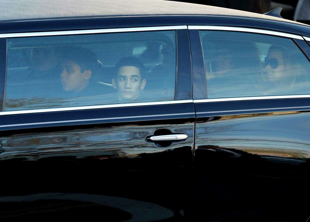 Family members of New York City police officer Rafael Ramos, including his son Jaden Ramos, center, and his wife Maritza Ramos, right, arrive before funeral services for officer Ramos at Christ Tabernacle Church, in the Glendale section of Queens, Saturday, Dec. 27, 2014, in New York. Ramos and his partner, officer Wenjian Liu, were killed Dec. 20 as they sat in their patrol car on a Brooklyn street. The shooter, Ismaaiyl Brinsley, later killed himself. (AP Photo/Julio Cortez)