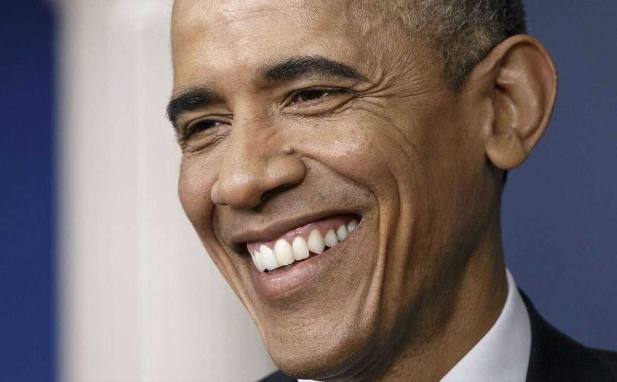 President Barack Obama smiles during a news conference in the Brady Press Briefing Room of the White House in Washington, Friday, Dec. 19, 2014. The president claimed an array of successes in 2014, citing lower unemployment, a rising number of Americans covered by health insurance, and an historic diplomatic opening with Cuba. He also touts his own executive action and a Chinese agreement to combat global warming. (AP Photo/J. Scott Applewhite)